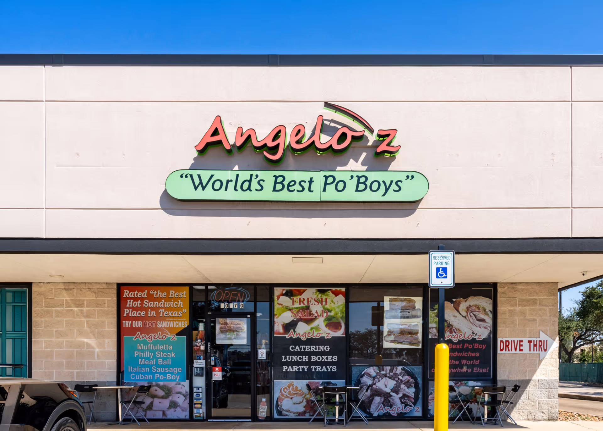 Exterior of Angelo'z restaurant with sign saying World's Best Po' Boys and drive-thru arrow.