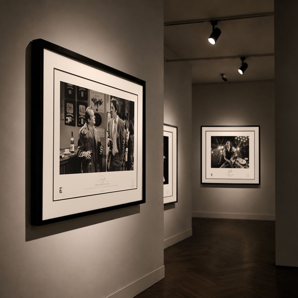 Framed celebrity artwork displayed in gallery