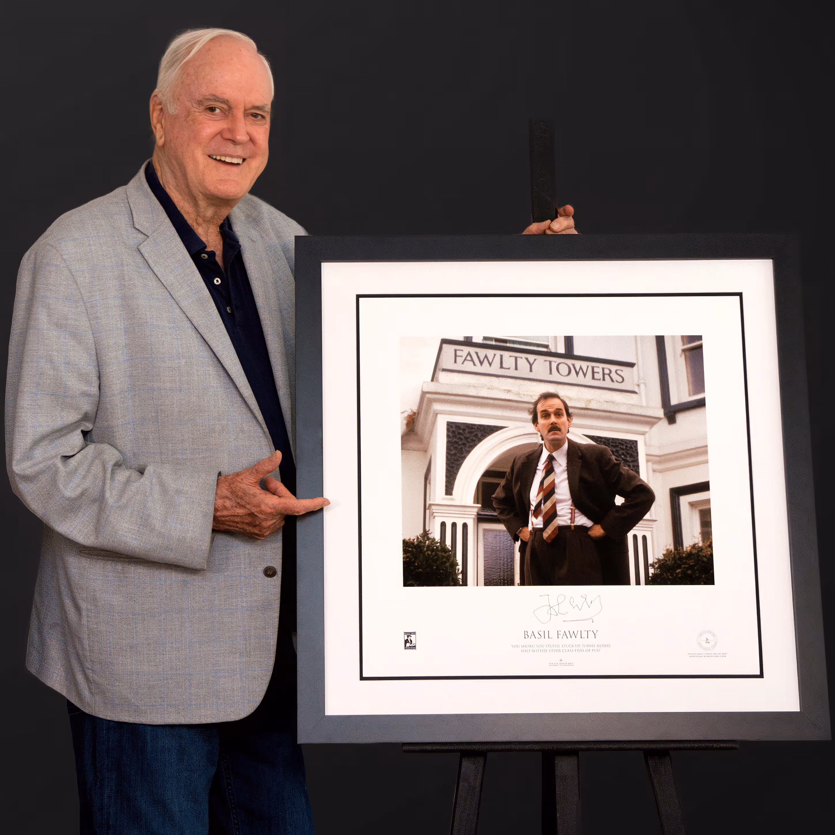 Man presenting framed signed memorabilia