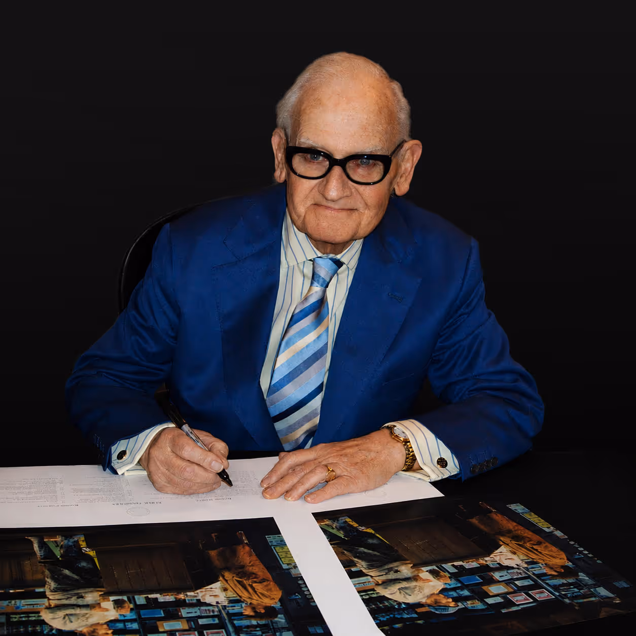 Man signing fine art memorabilia
