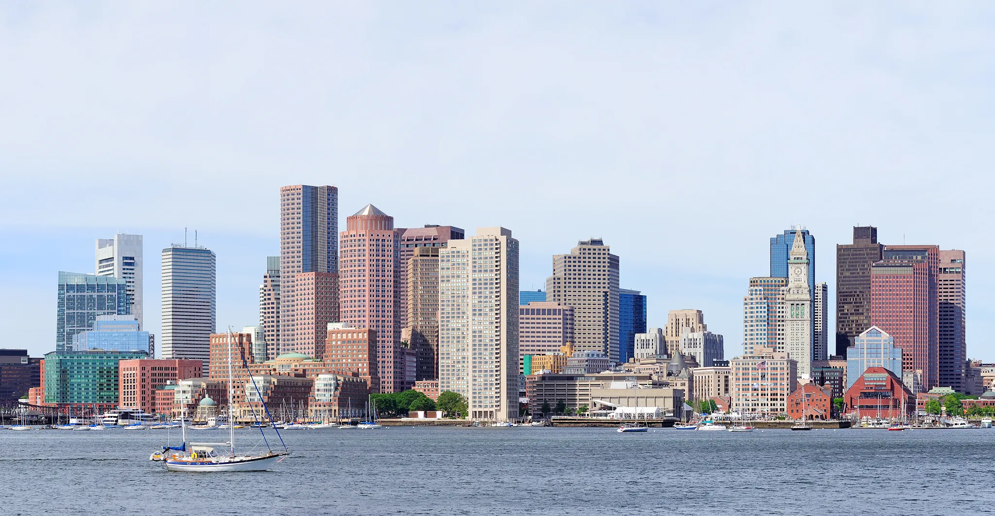 Boston skyline with skyscrapers and waterfront during autumn in evening light.