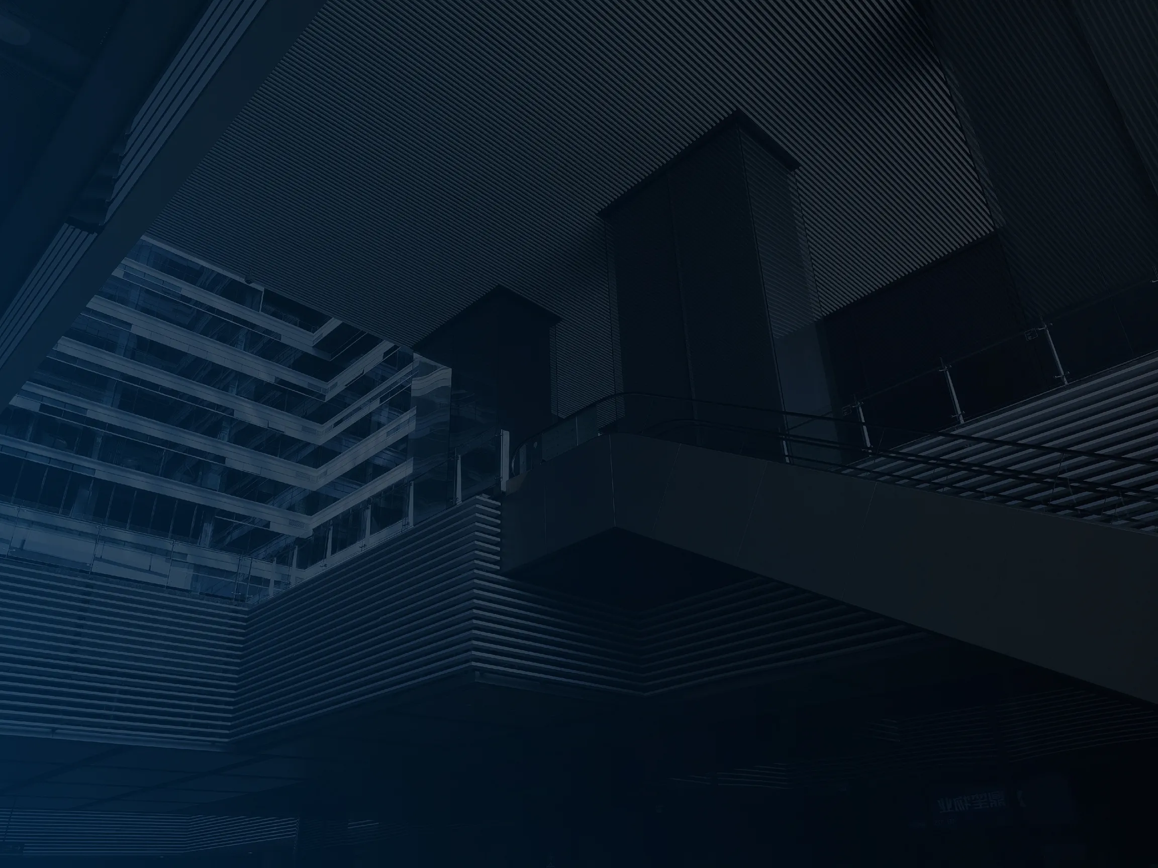 Modern building interior with glass railings and horizontal slatted ceiling and walls.