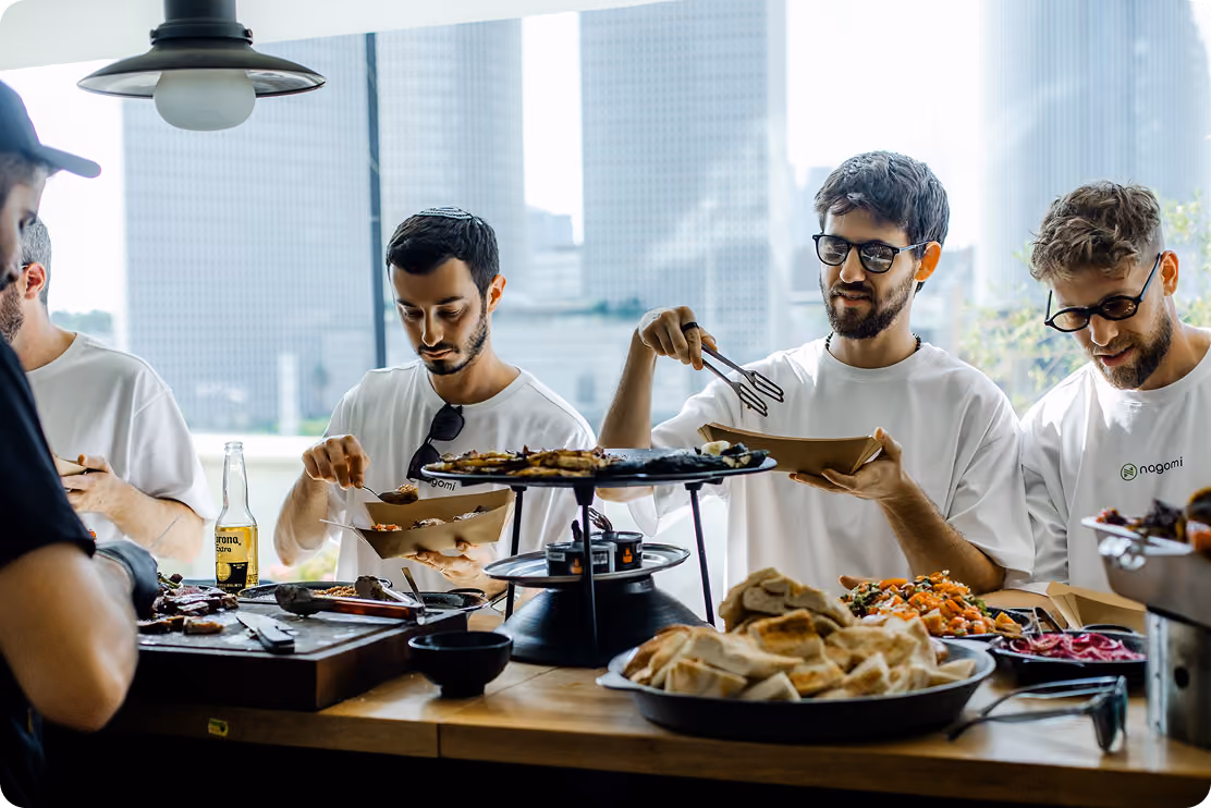 Nagomi team members sharing food around a table
