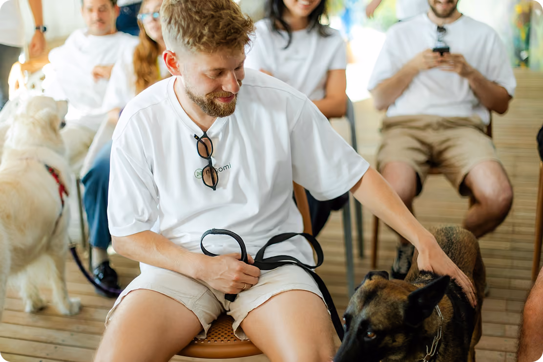 Nagomi team member petting a dog at an outdoor company event