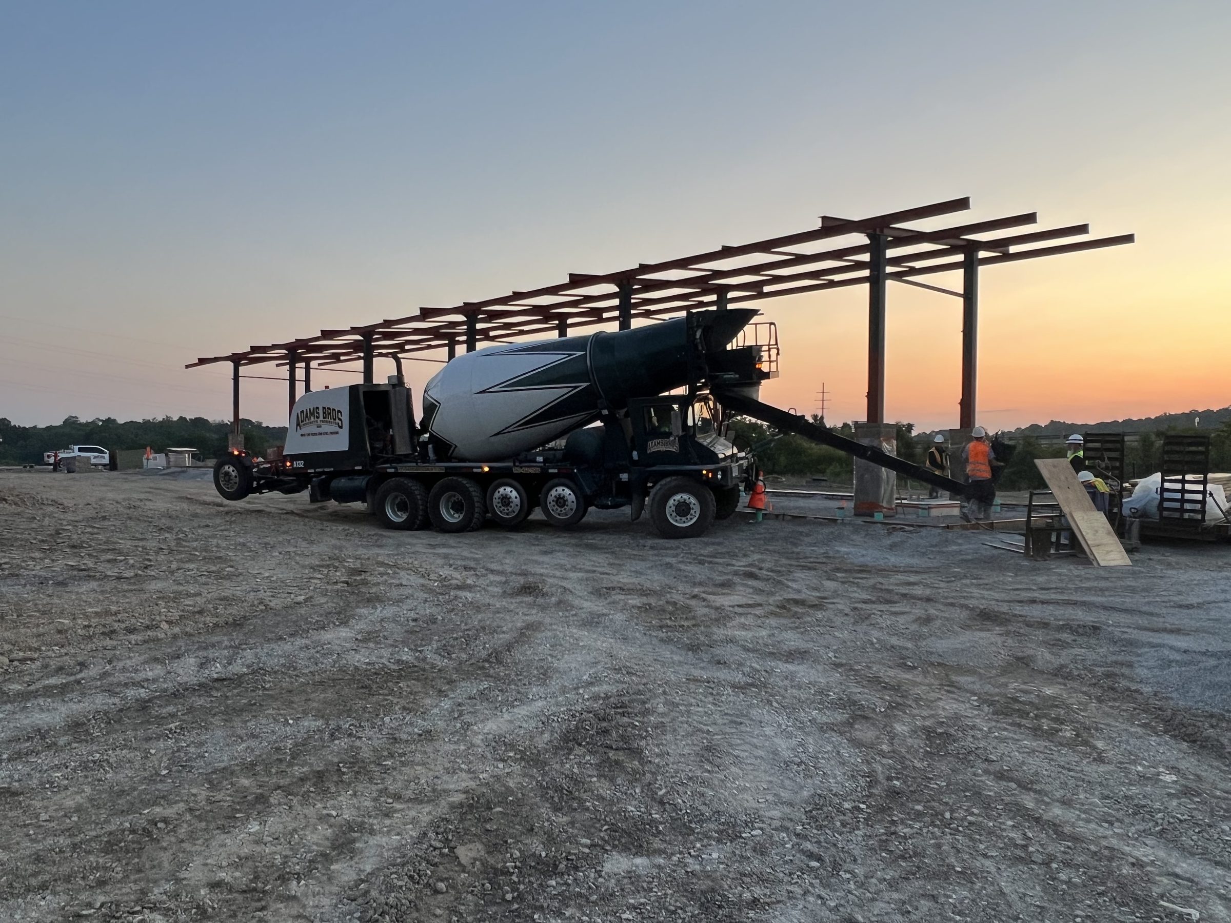 Adams Bros. ready mix truck on a job site at sunset