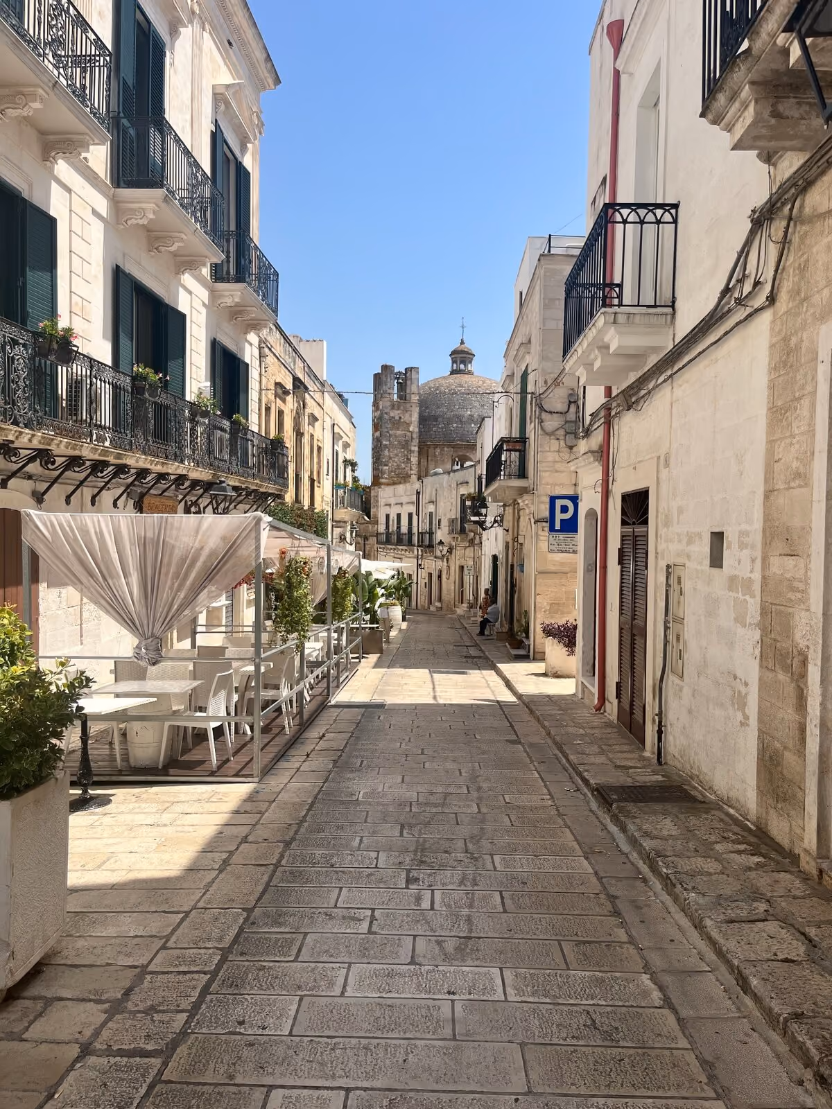 A sunlit street through the historic centre of Ceglie Messapica