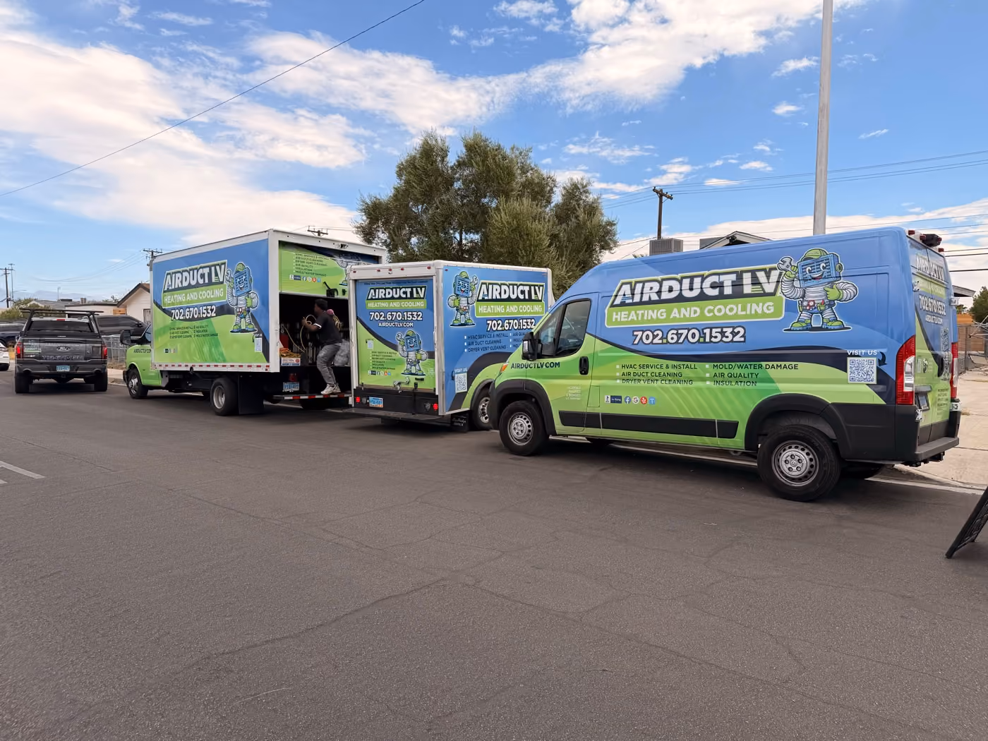 The Air Duct LV fleet parked on a Las Vegas street before a job.