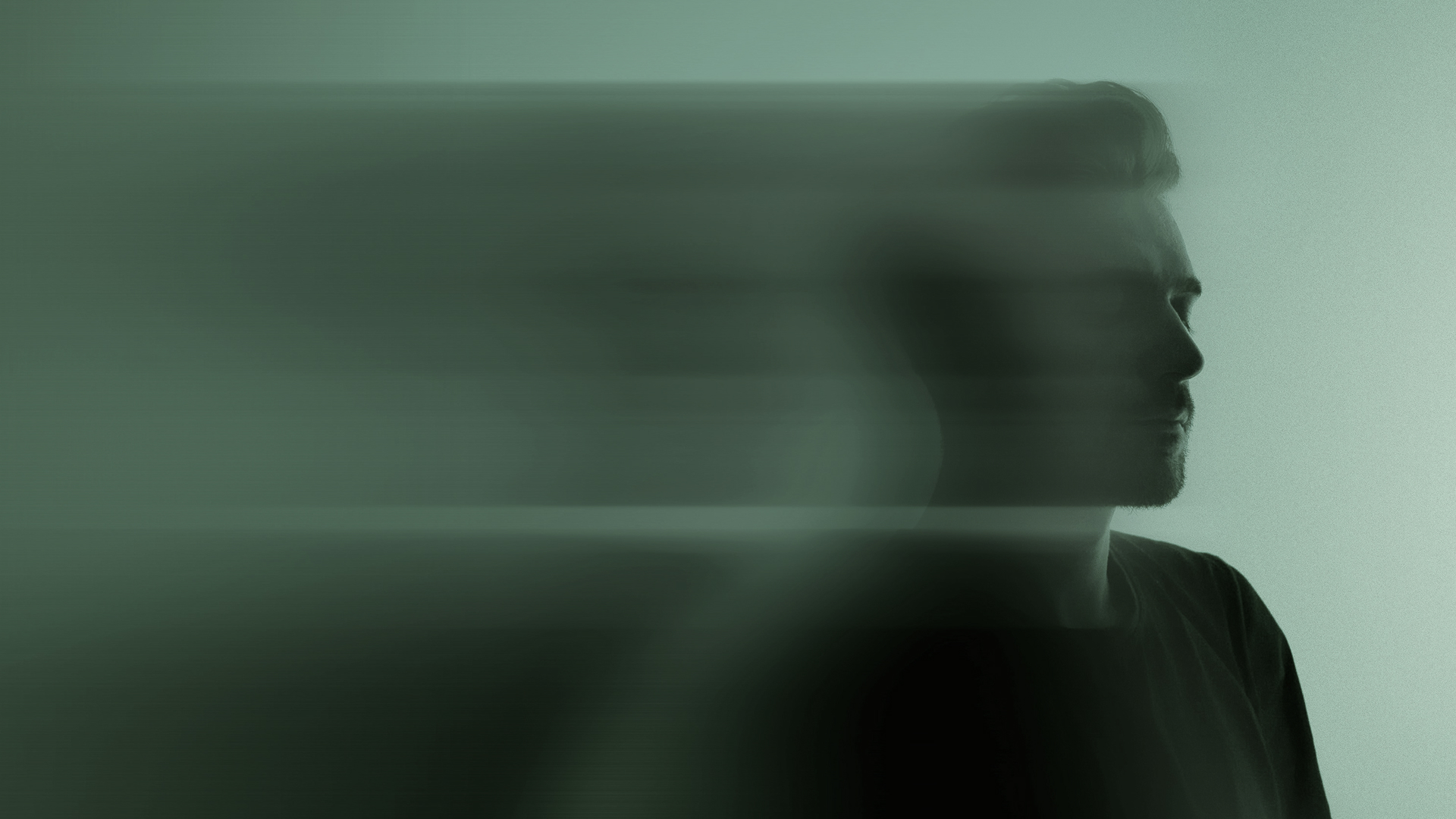 Side profile of a man with a blurred motion effect trailing behind his head.