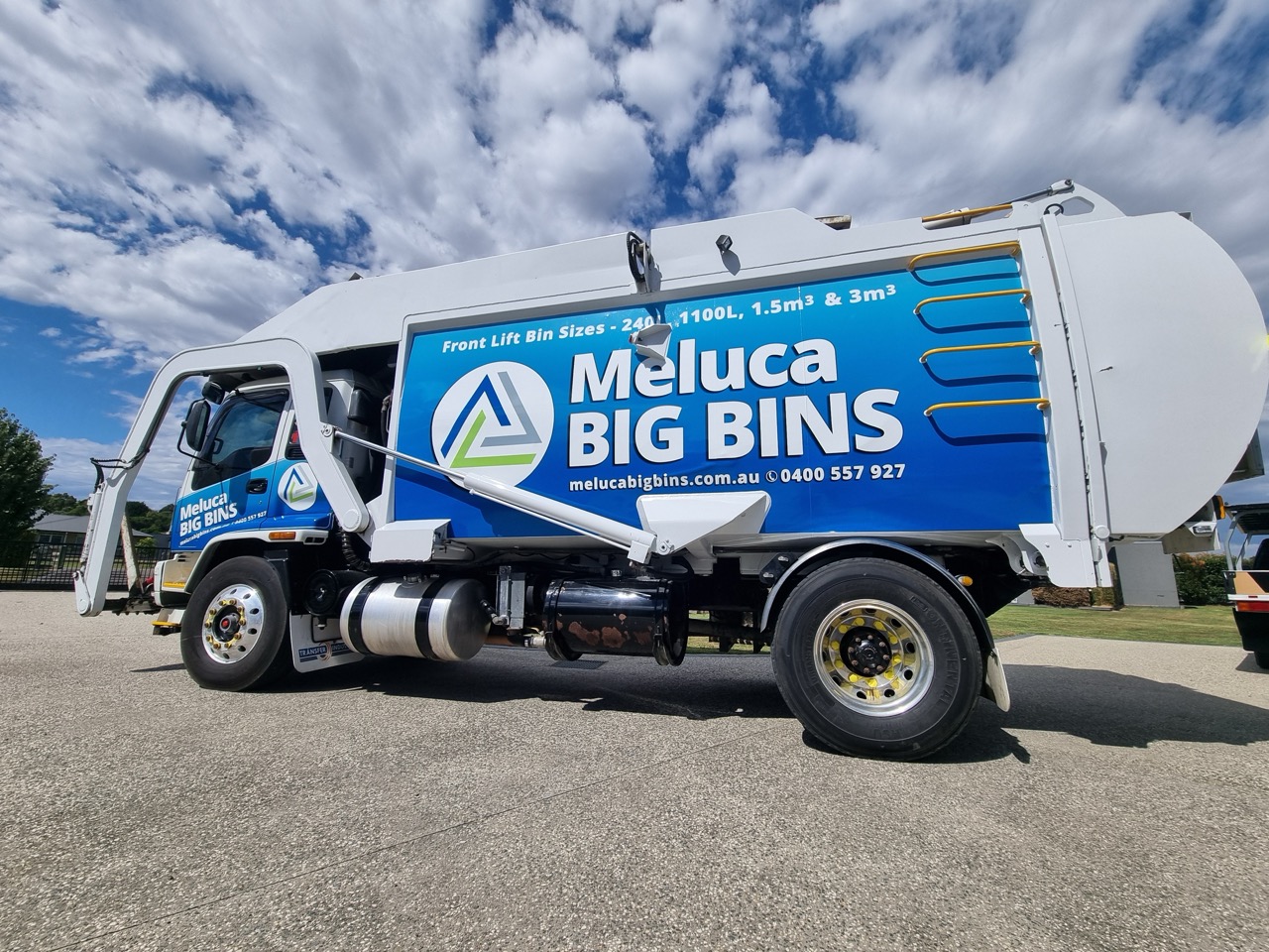A blue Meluca Big Bins truck wrapped in blue by MC Graifx