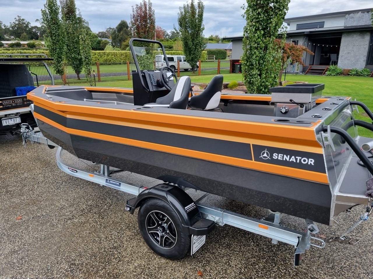 A mercedes benz boat on a trailer in a driveway wrapped by MC Grafix 