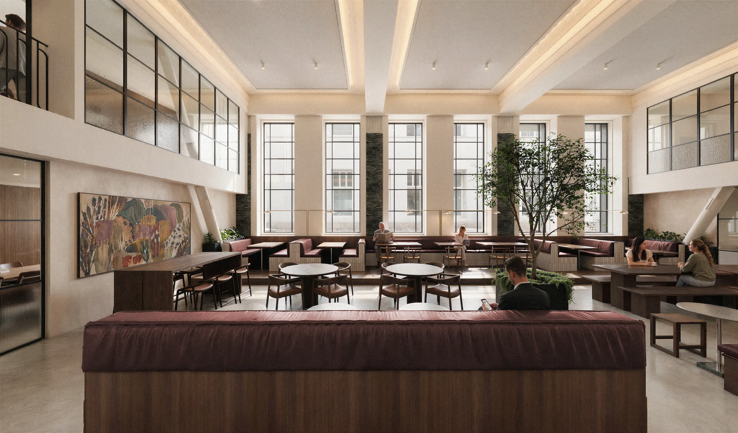 Modern spacious indoor lounge area with large windows, leather seating, round tables, wooden benches, a central indoor tree, and people engaged in conversation or reading.