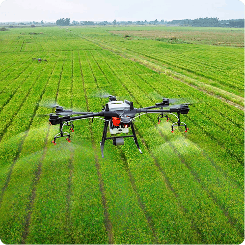Agriculture drone spraying crops over a large green field with multiple spray nozzles active.