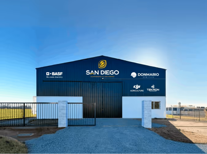 Blue industrial building with San Diego logo and agriculture service logos on the front wall.