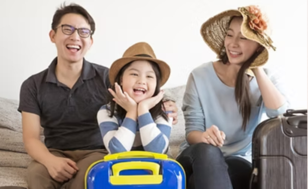 Family excited and ready for vacation with luggage, planning their trip with a travel advisor.