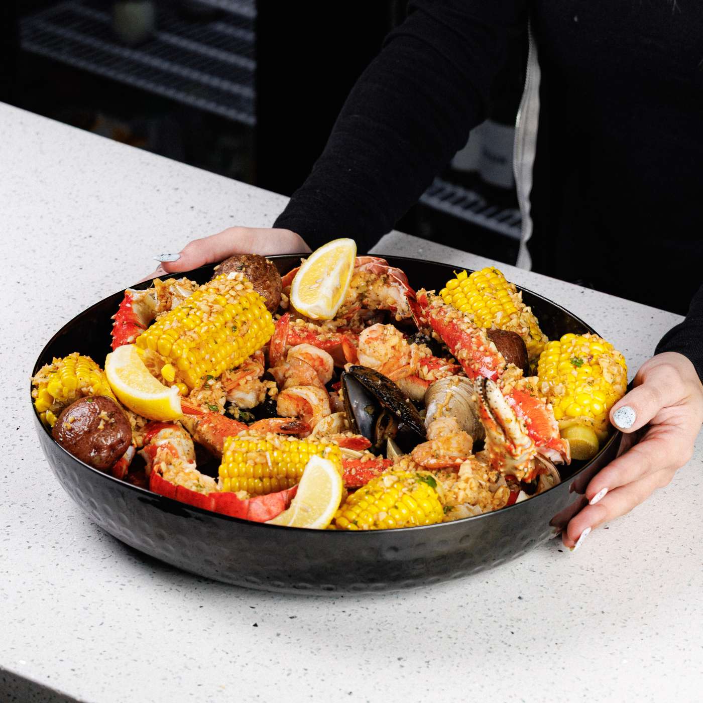Catering spread of seafood platters and trays from PJ Lobster House