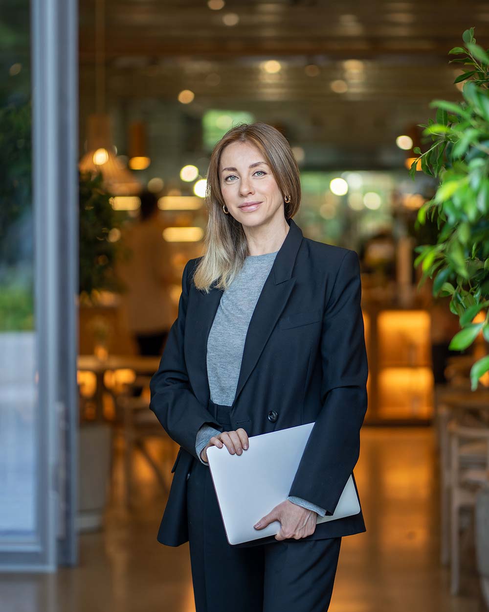 Confident businesswoman holding a laptop, representing flexible working capital funding options from Bizcap.