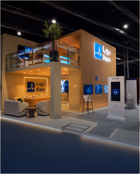 Modern Bupa exhibition booth with seating area and digital displays at an indoor event.