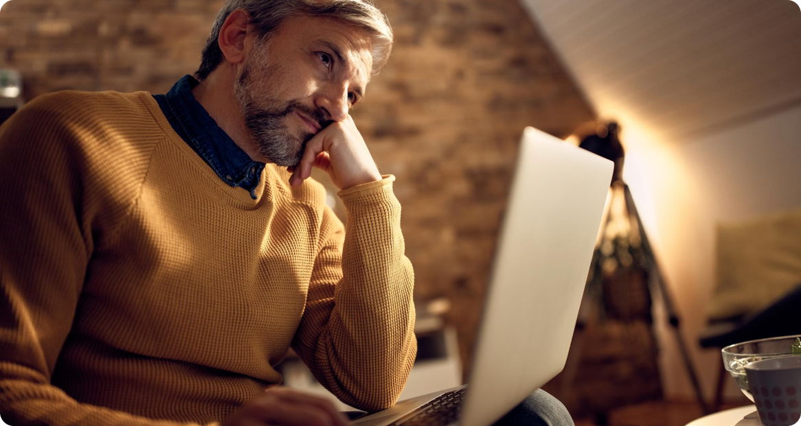 Man looking worried at his laptop while trying to cancel a subscription
