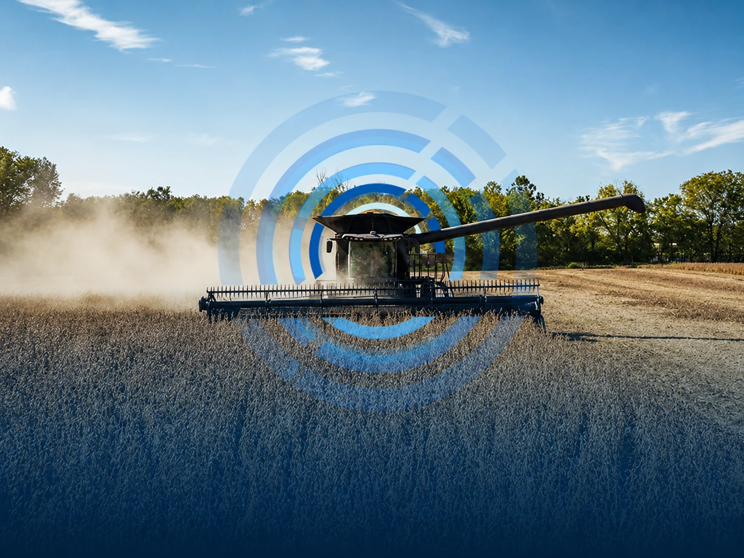 Combine harvester working in a field under a blue sky with trees in the background, with semi-transparent blue circular graphic overlay indicating monitoring or data technology.