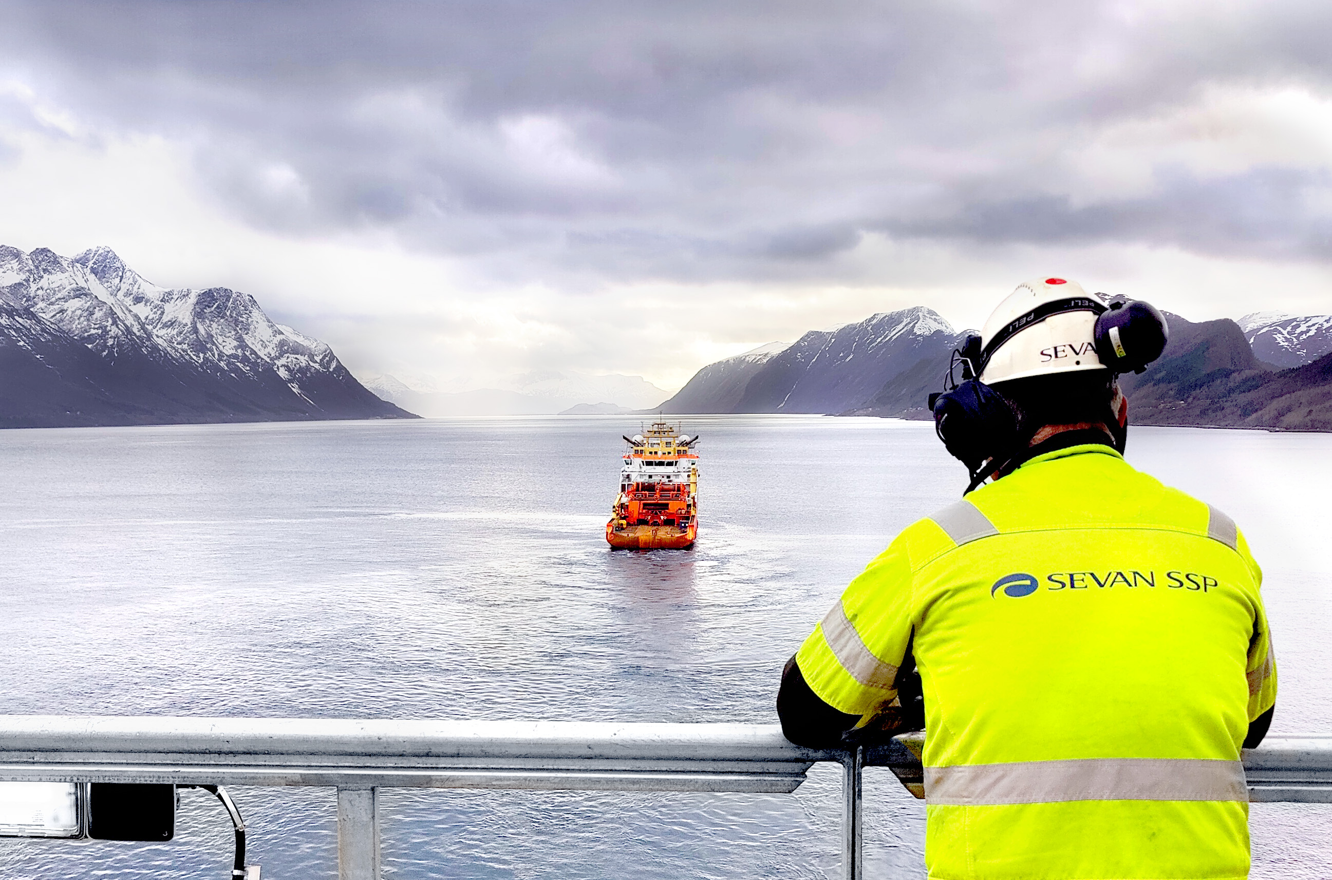 Worker looking at a ship from another ship