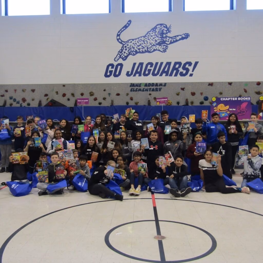 Jane Addams Elementary school students holding up books