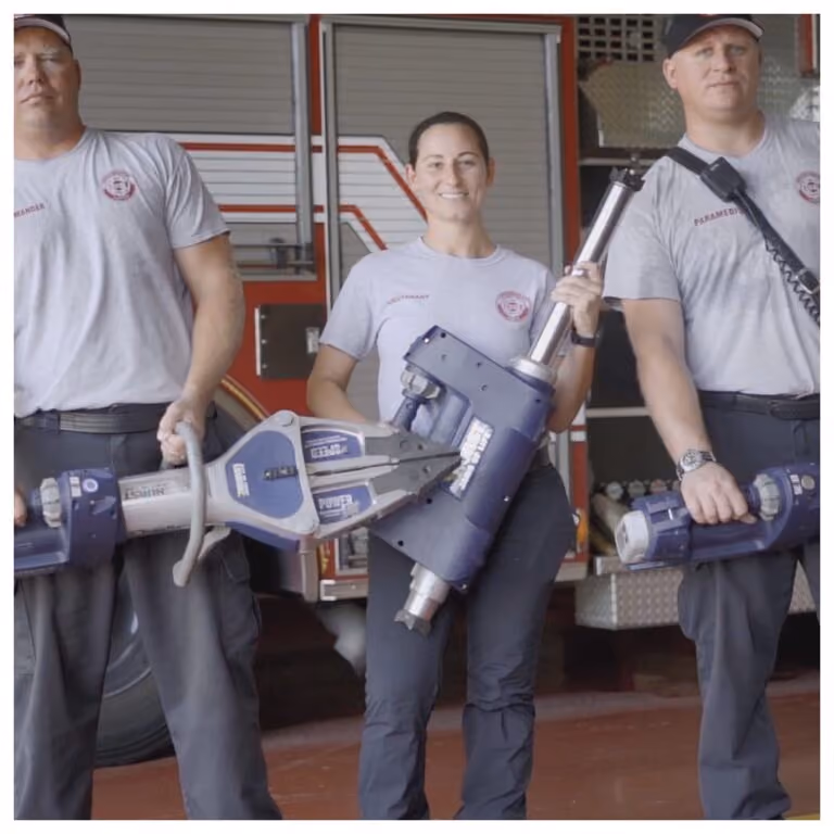 Several fire fighters holding the HURST Jaws of Life