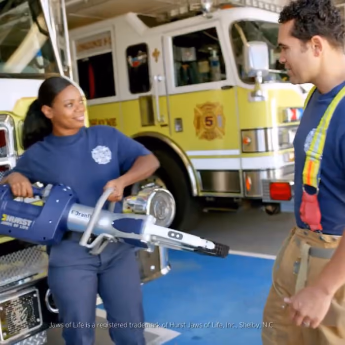 A fire fighter holding a pair of HURST Jaws of Life