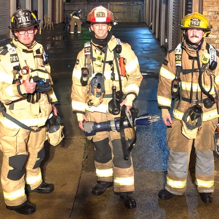 A photograph of three fire fighters