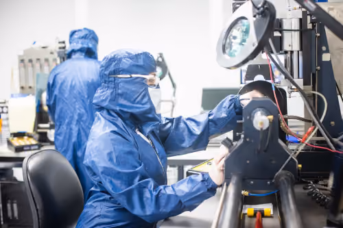 A lab technician working with a device