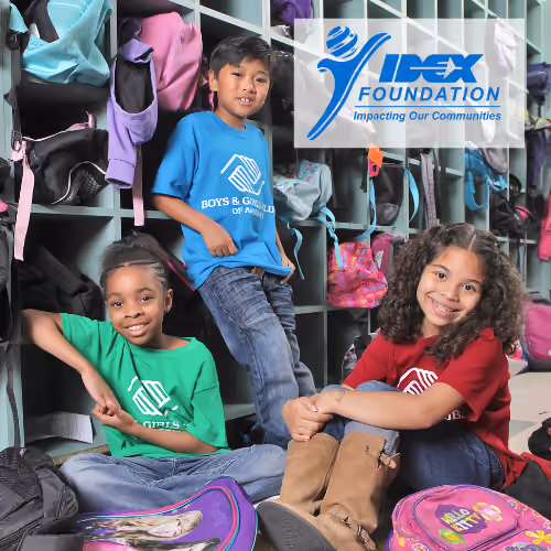 A group of three children wearing Boys and Girls club tshirts