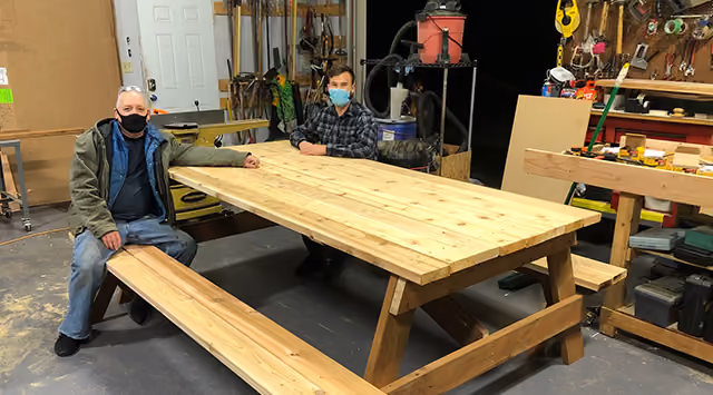 A man sitting at a large picnic table