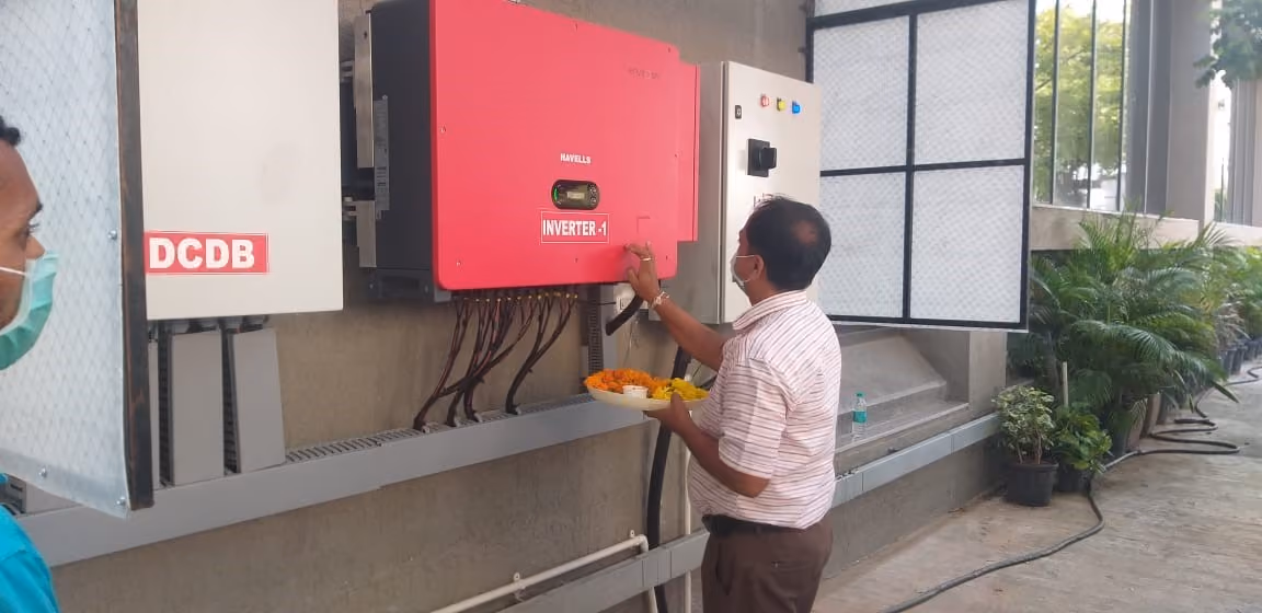 A man holding a plate of food at an inverter