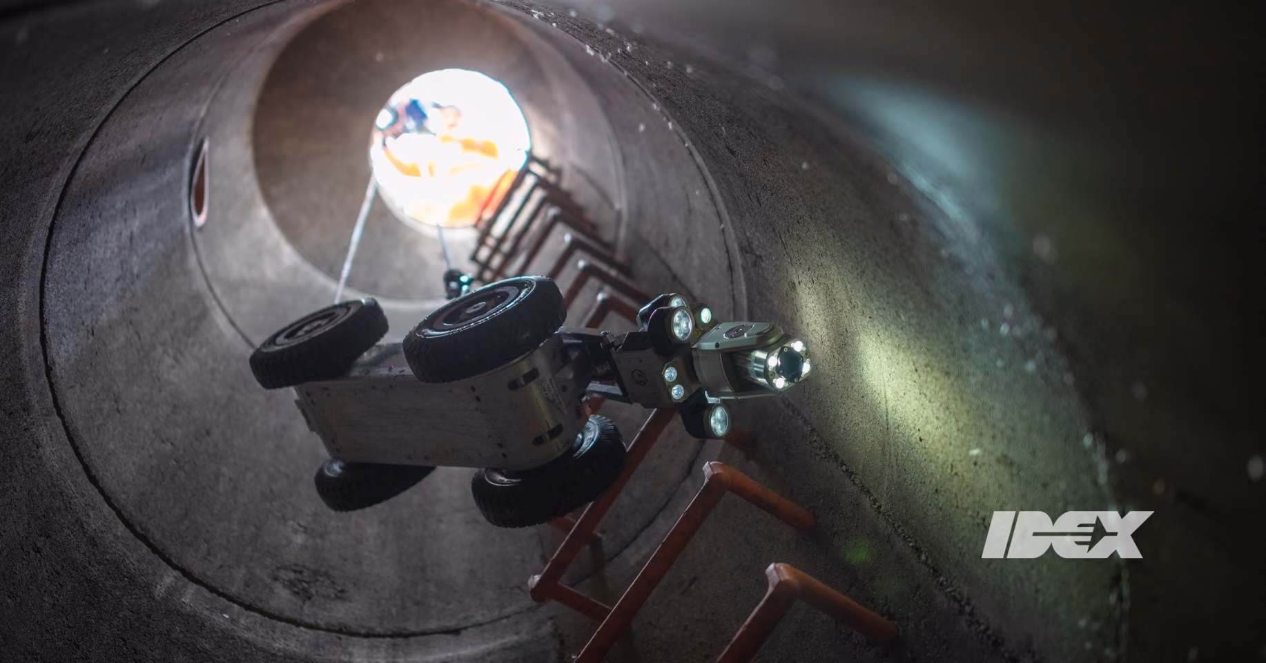 An IDEX drone being lowered into a access pipe