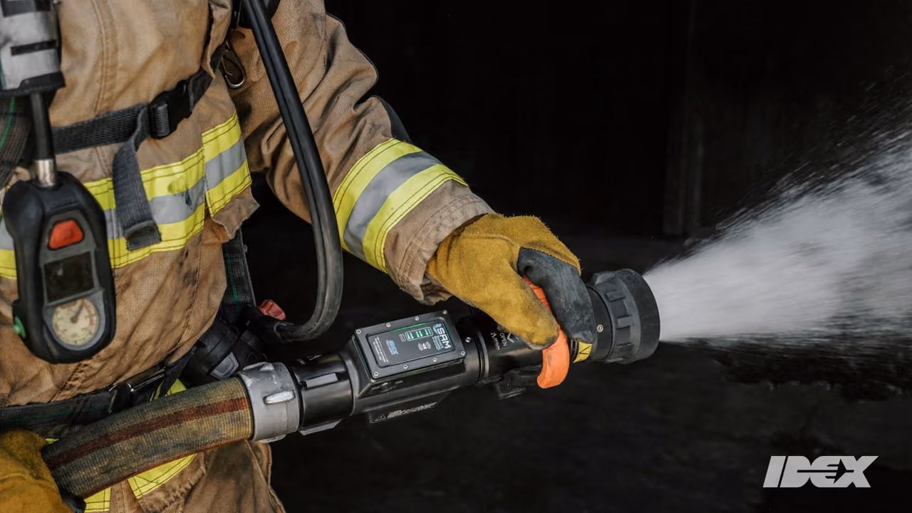 A photograph of a firefighter using a hose