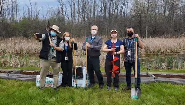 IDEX Health & Science team members holding landscaping tools