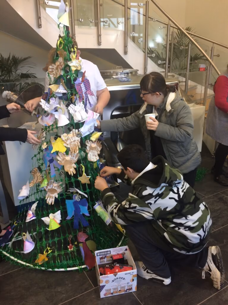 The Vale of Evesham School placing the decorations on the tree