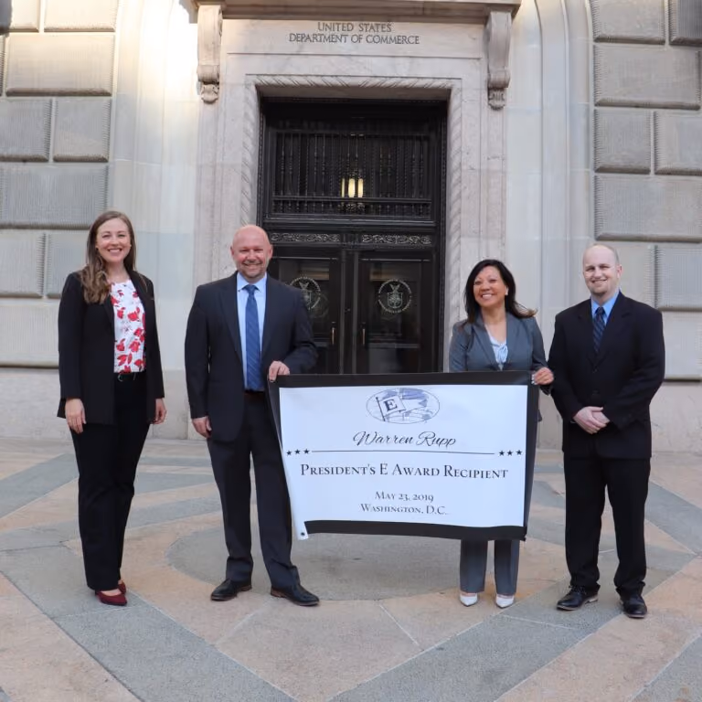 Warren Rupp team members holding their award banner