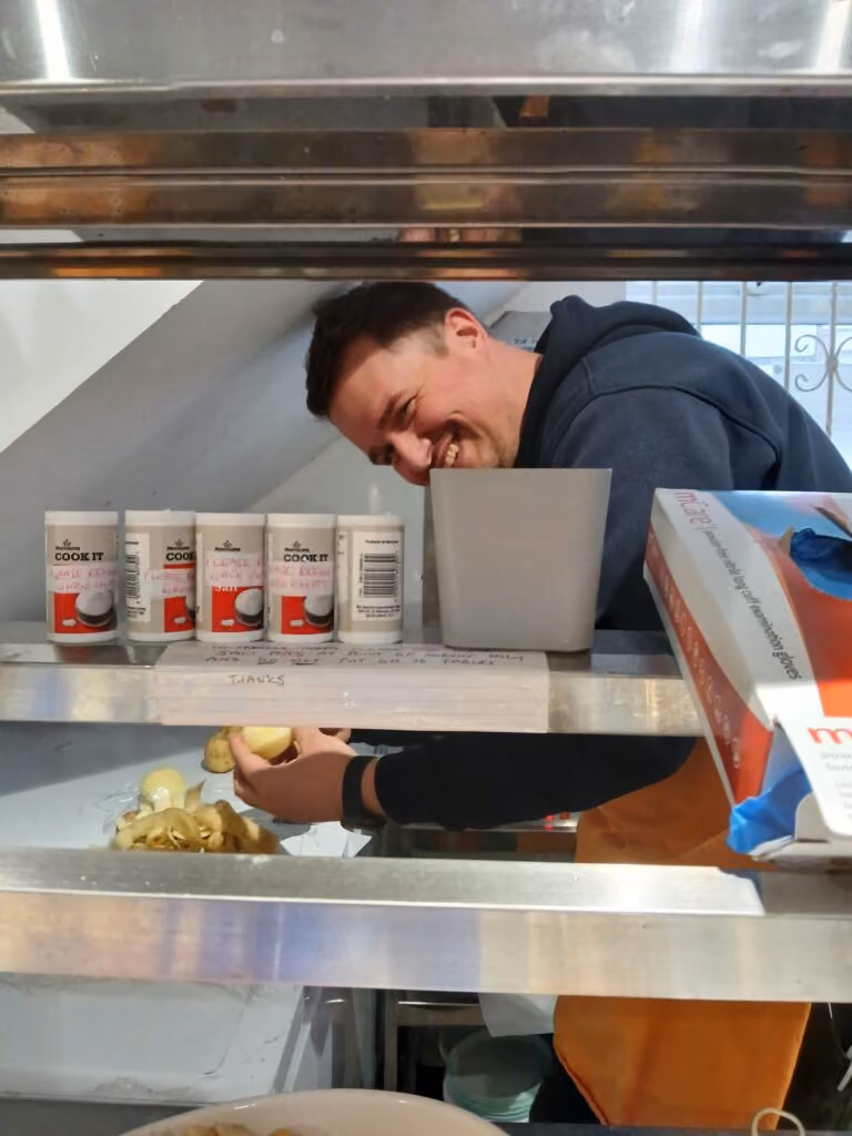 A member of the Godiva team pealing potatoes