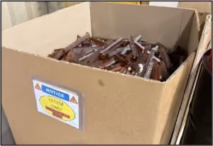 A cardboard box filled with recycled plastic