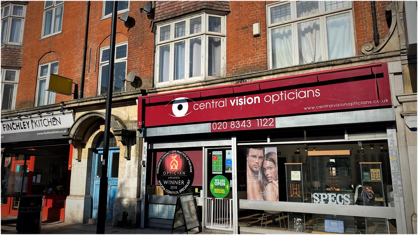 Street view of Central Vision Opticians storefront with signage, posters, and social distancing signs.