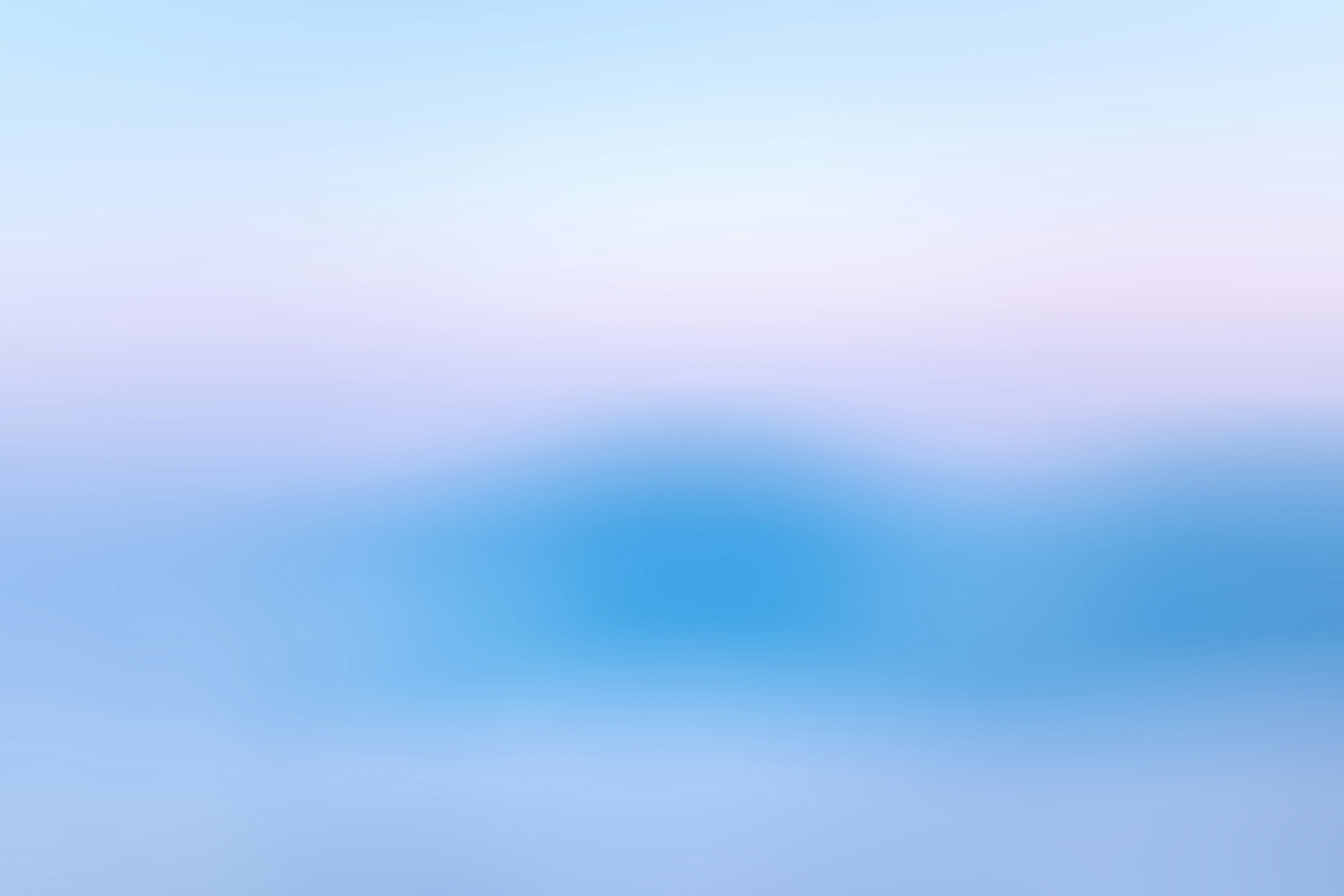 Dégradé de couleur douce allant du bleu clair en bas au rose pâle puis au bleu ciel en haut.