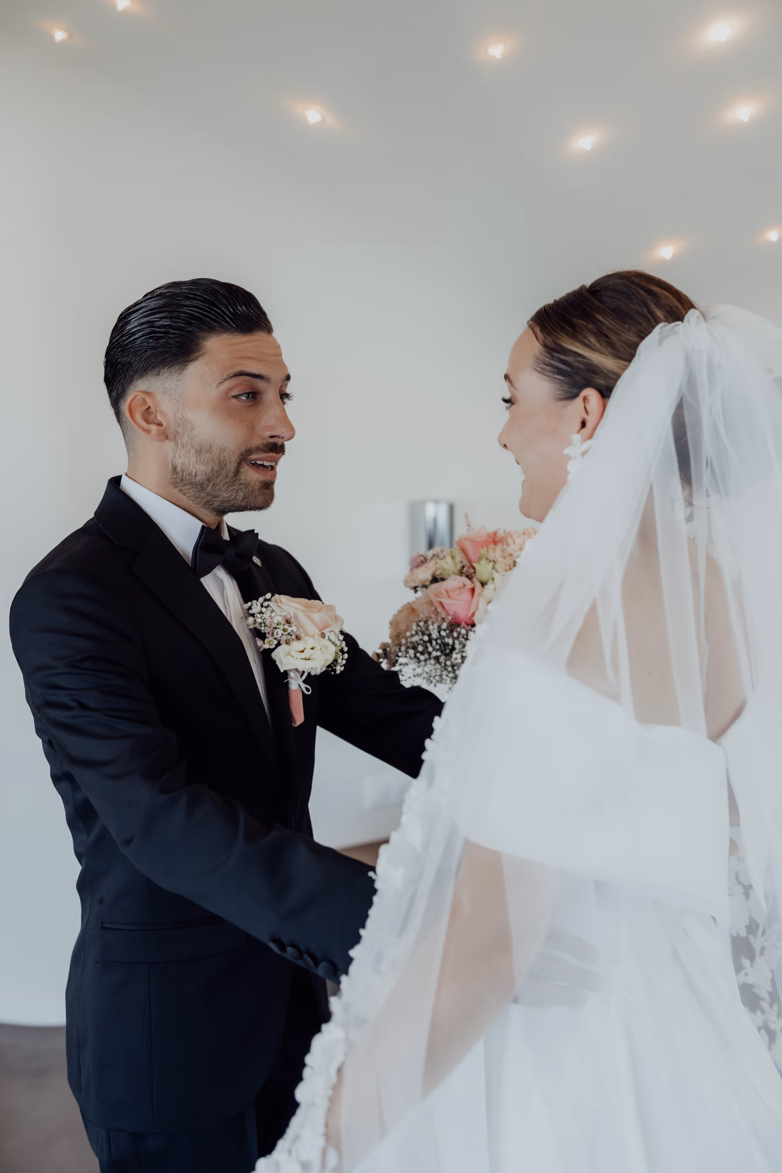 First look moment — groom seeing bride for first time, wedding photography by Lee Kramer