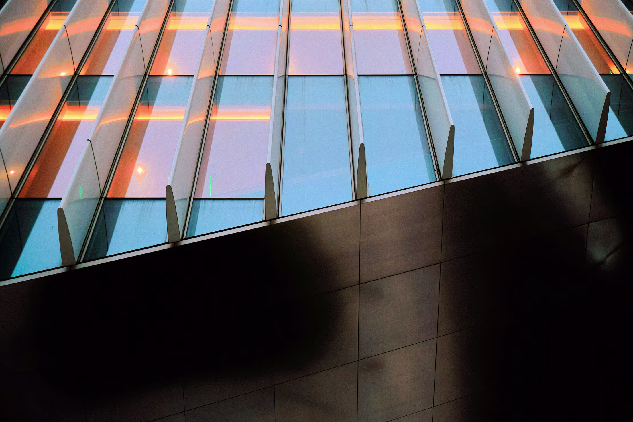 Close up of a tall building with sunlight reflecting off the windows