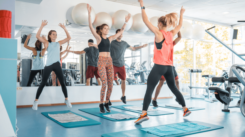 a group of people doing exercises in a gym