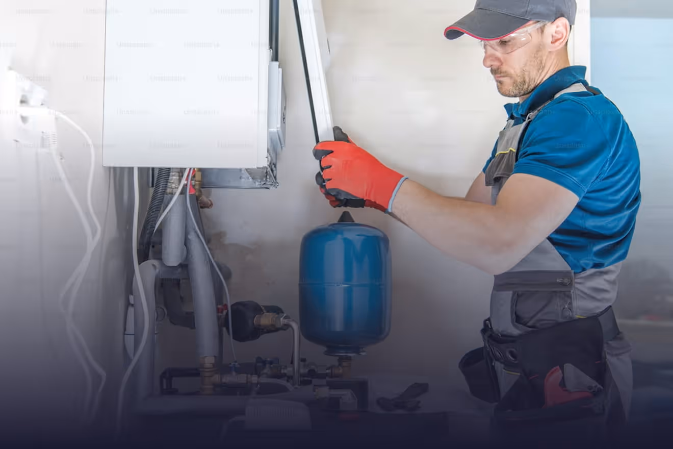 HVAC technician servicing heating system components at Bakersfield California home