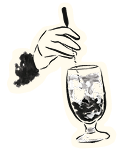Hand stirring a cocktail glass filled with ice cubes.