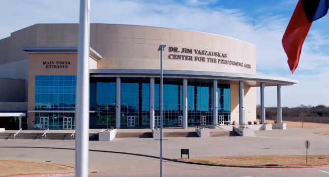 Exterior of Dr. Jim Vaszauskas Center for the Performing Arts with glass windows and main tower entrance.