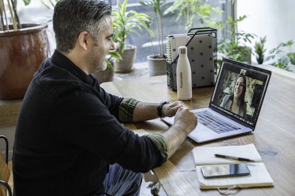 A salesperson working in an office on a virtual call