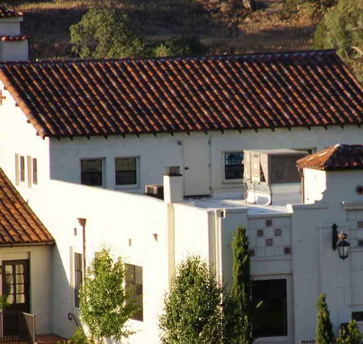 Red tile roofs and white stucco walls of Villa La Paz's mission-style buildings