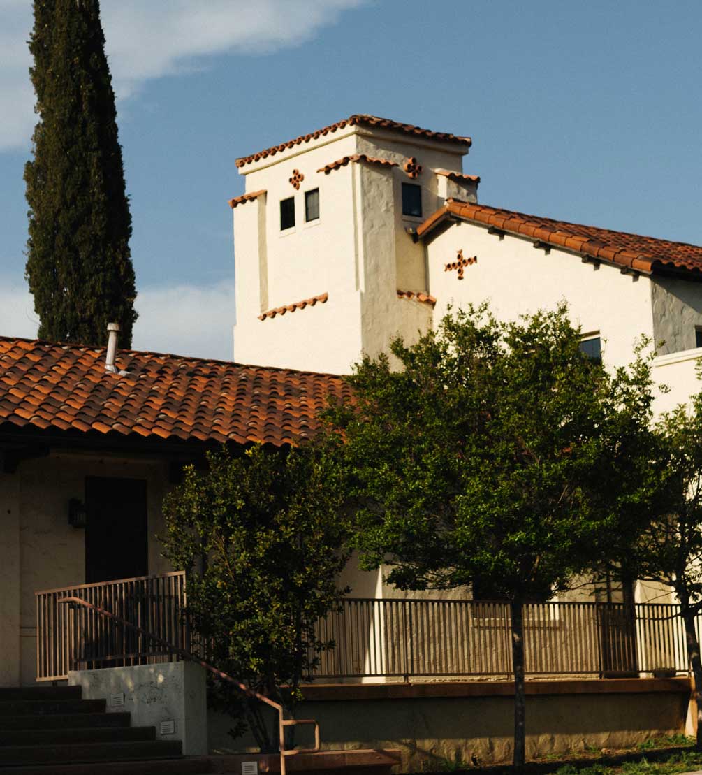 Mission-style Villa La Paz building with white stucco tower and red tile roofs